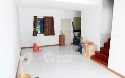 Spacious unfurnished living room with staircase and natural light