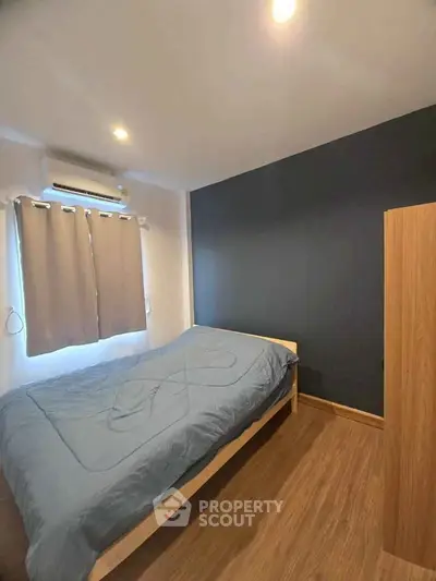 Cozy bedroom with wooden flooring and modern decor