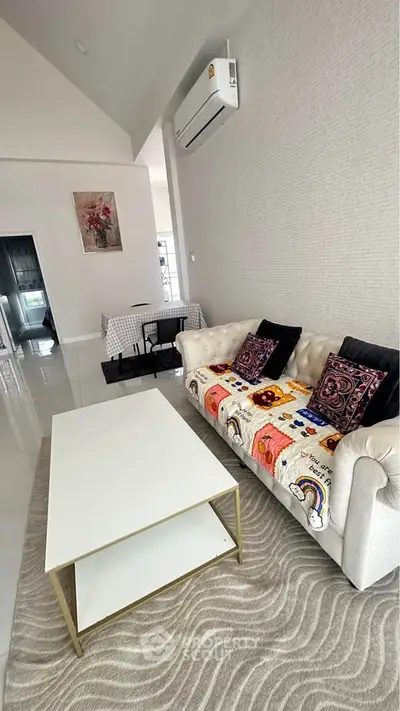 Stylish living room with modern decor, featuring a plush sofa, chic coffee table, and elegant wall art.