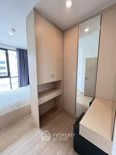 Modern bedroom with built-in wardrobe and natural light
