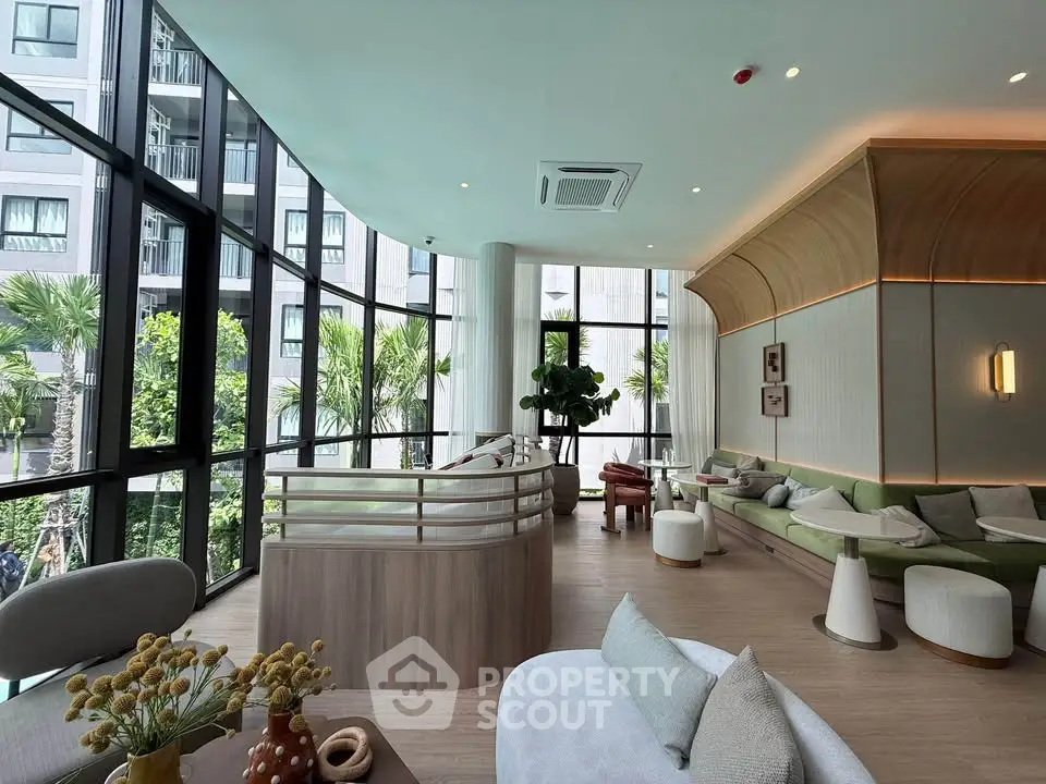 Luxurious modern living room with floor-to-ceiling windows and stylish decor in a high-rise building.