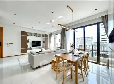 Spacious modern living room with dining area and large windows offering city views.