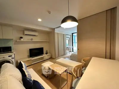 Modern living room with open layout, stylish furniture, and natural light