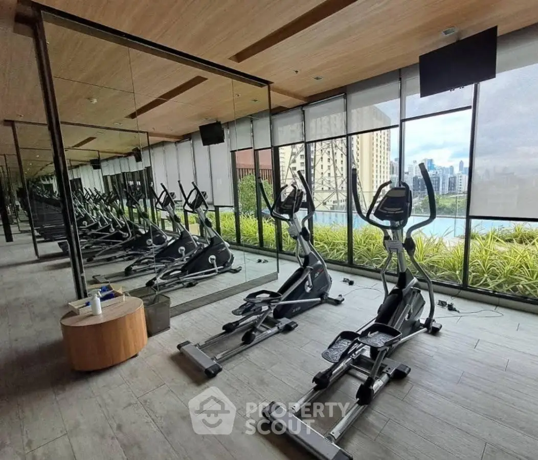 Modern gym with city view and exercise equipment in luxury building