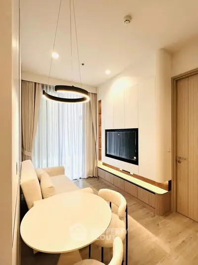 Modern living room with elegant lighting and cozy seating area in a stylish apartment.