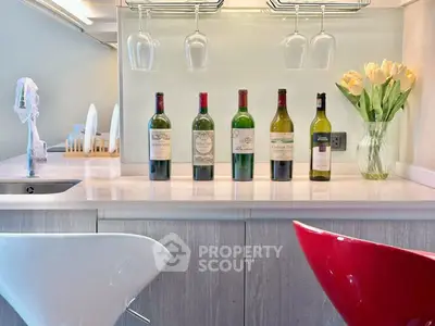 Stylish modern kitchen with wine bottles and elegant bar stools