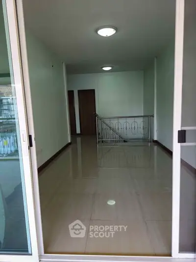 Spacious interior with sleek flooring and modern lighting, ideal for versatile living space.