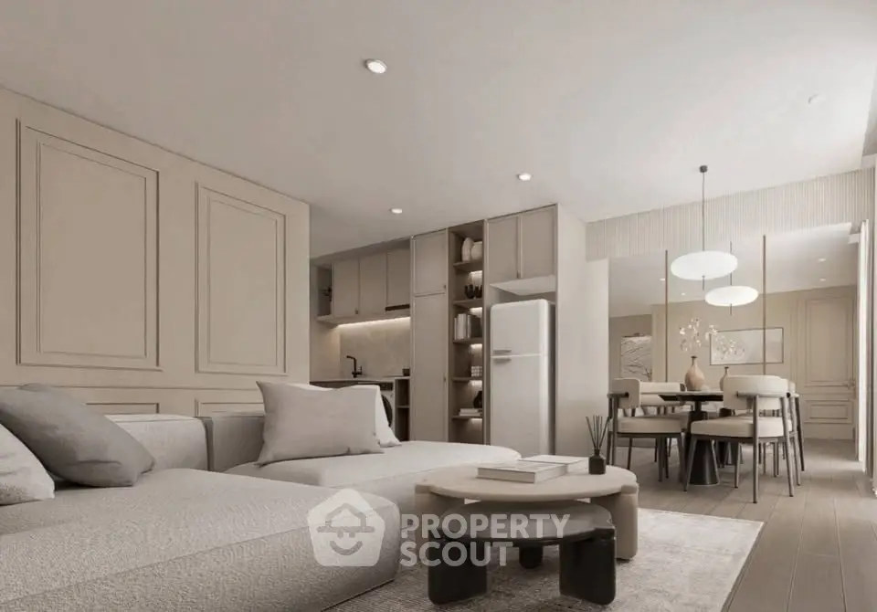 Modern living room with open kitchen, elegant decor, and cozy seating area in neutral tones.