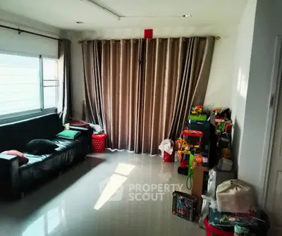 Spacious living room with large window and modern decor