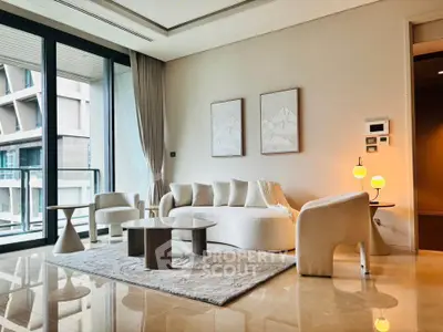 Luxurious modern living room with elegant furniture and floor-to-ceiling windows in a high-rise apartment.