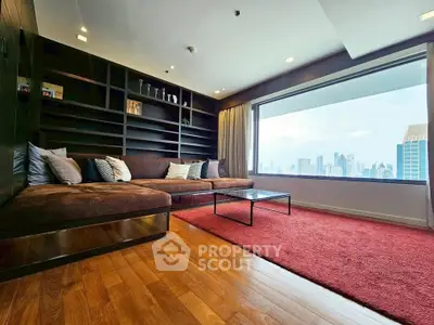 Luxurious living room with panoramic city view and elegant wooden flooring.