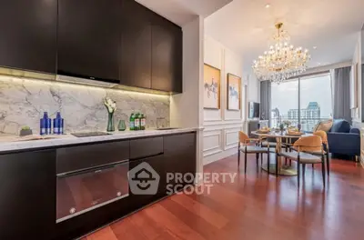 Luxurious open layout kitchen and dining area with city view and elegant chandelier.