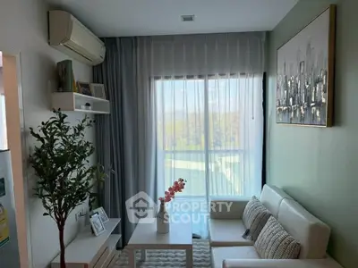 Charming living room with modern decor, large window, and cozy seating area, perfect for relaxation.