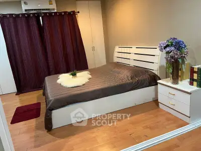 Cozy bedroom with elegant decor and wooden flooring, featuring a stylish bed and chic curtains.