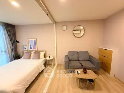 Modern studio apartment with cozy living area and stylish decor