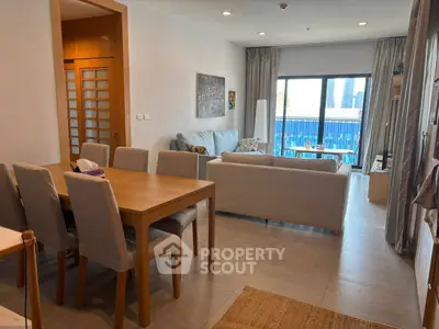 Spacious living room with modern furniture and city view, perfect for urban living.