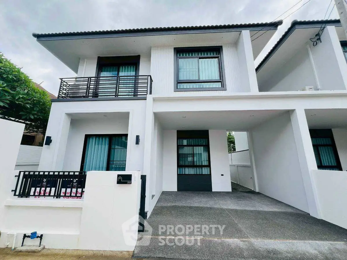 Modern two-story house with sleek design and spacious driveway in a serene neighborhood.