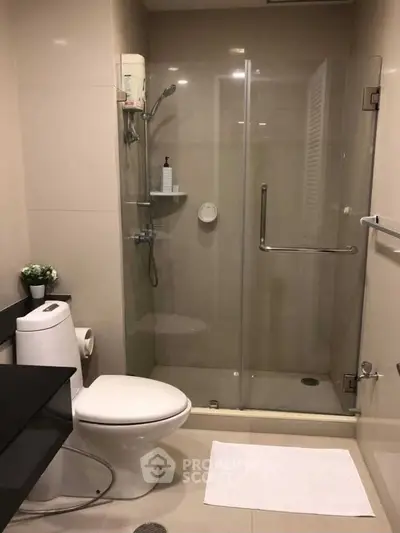 Modern bathroom with glass shower enclosure and sleek fixtures