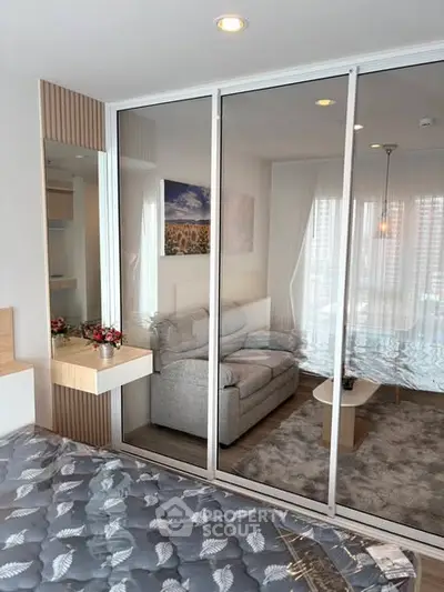 Modern bedroom with glass partition and cozy living area