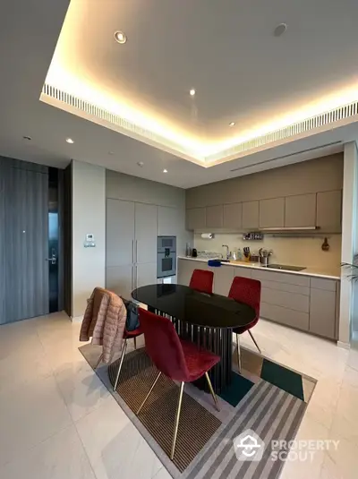 Modern kitchen with sleek cabinetry and stylish dining area in luxury apartment