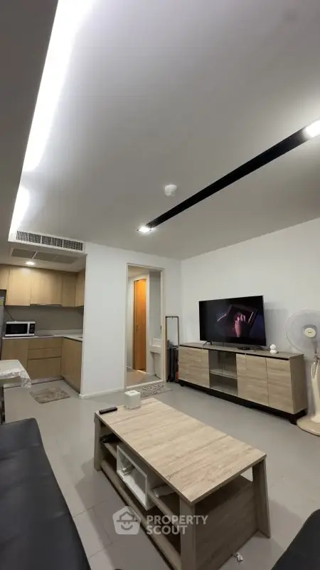 Modern living room with open kitchen and stylish furniture