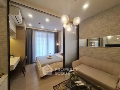 Modern bedroom with stylish decor and cozy seating area, featuring elegant lighting and large windows.