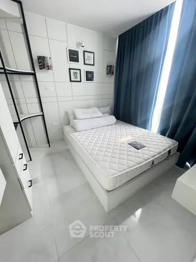 Modern minimalist bedroom with stylish decor and ample natural light