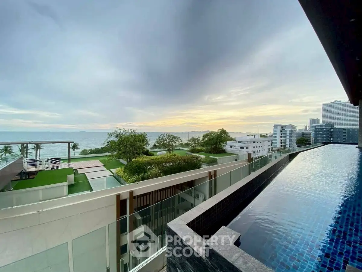 Luxurious rooftop pool with stunning ocean view in modern high-rise building.