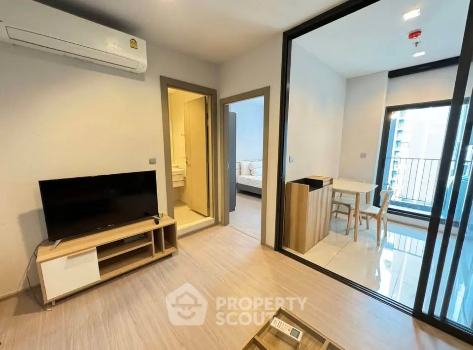 Modern apartment interior with living room, dining area, and balcony view.