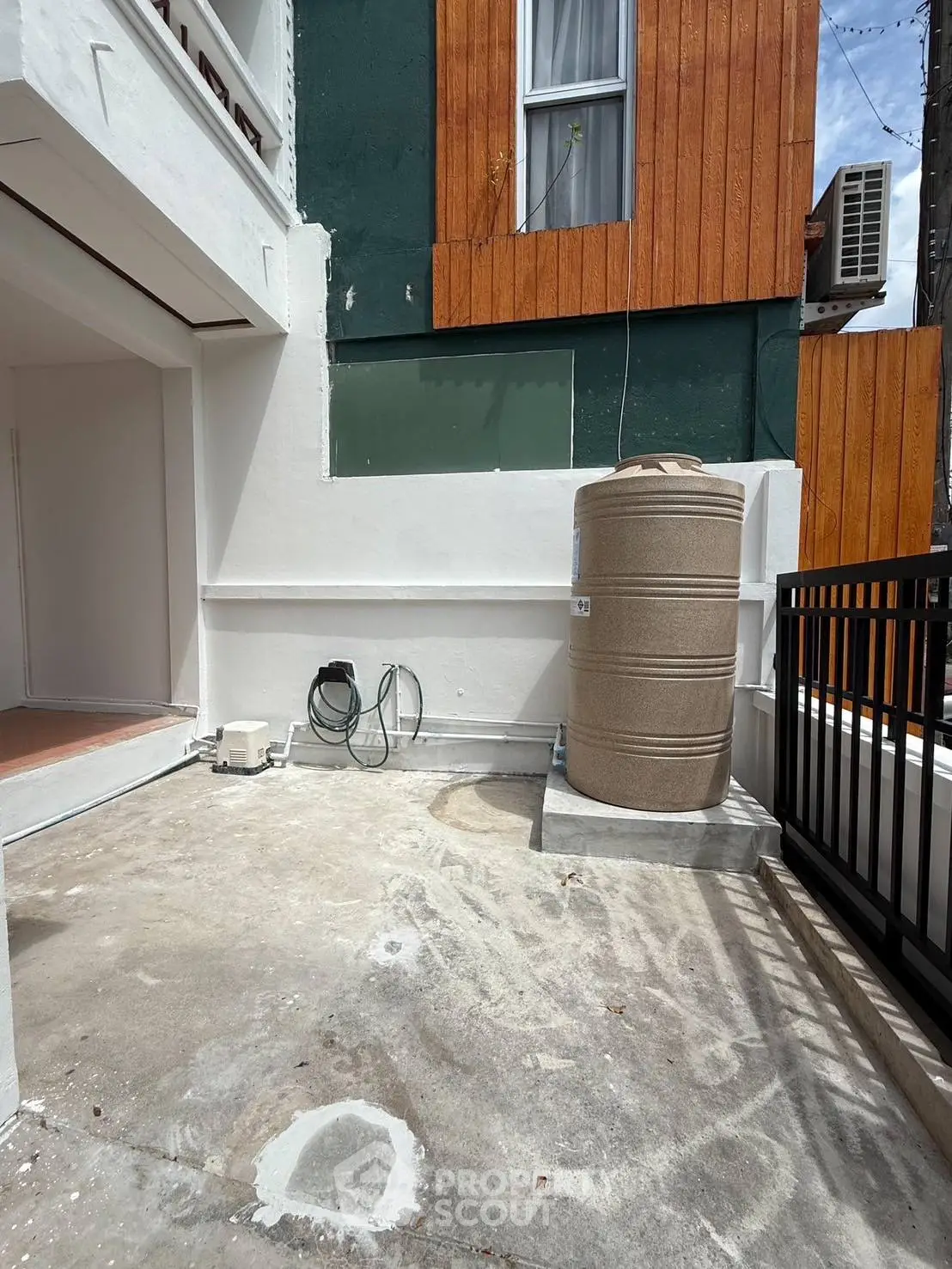 Spacious outdoor area with water tank and air conditioning unit