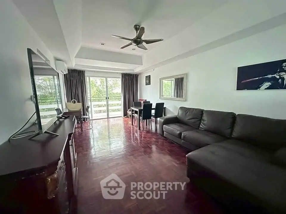 Spacious living room with modern decor and large windows for natural light.