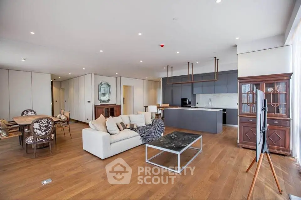 Spacious modern living room with open kitchen and elegant wooden flooring