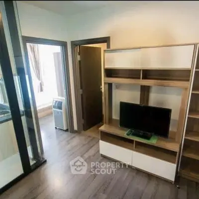 Modern living room with sleek wooden flooring and stylish TV unit