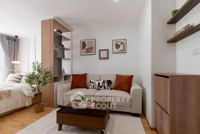 Modern living room with cozy sofa and stylish decor in open-plan apartment.