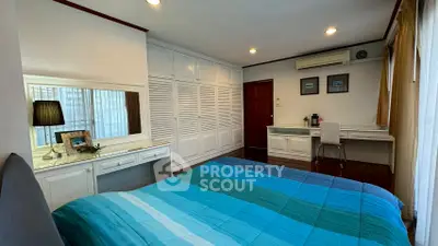 Spacious bedroom with built-in wardrobes and cozy decor
