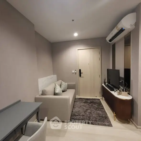 Modern living room with sleek furniture and air conditioning in a cozy apartment.