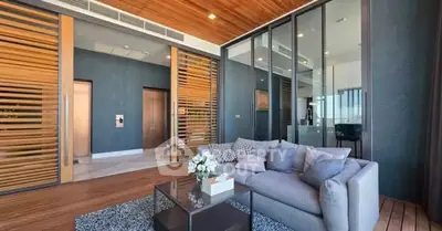 Luxurious modern living room with wooden accents and large glass doors in a high-end apartment.