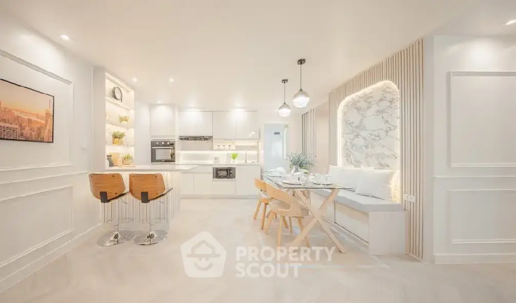 Luxurious open-plan kitchen and dining area with modern decor and elegant lighting.
