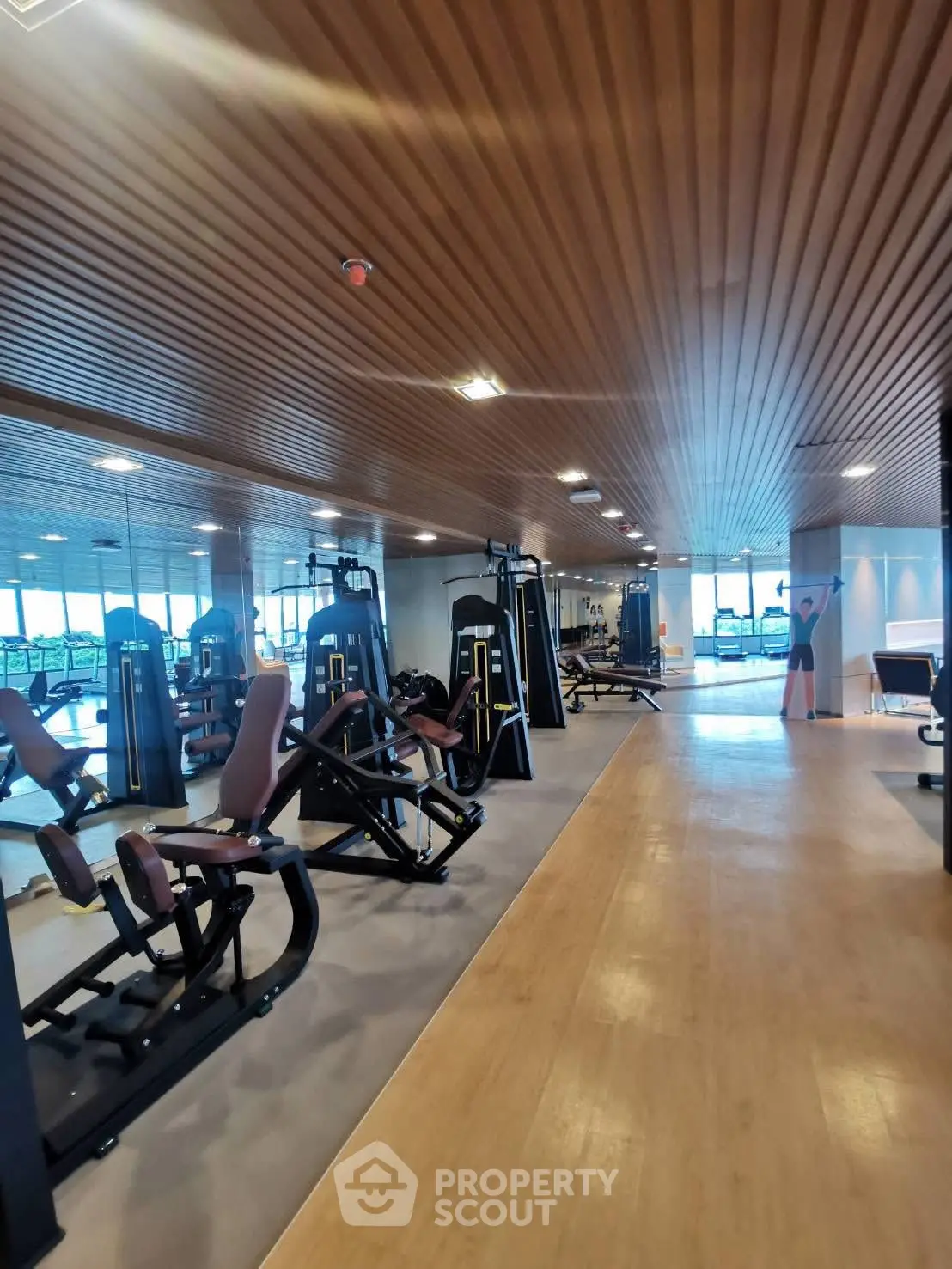Modern gym with state-of-the-art equipment and wooden ceiling design