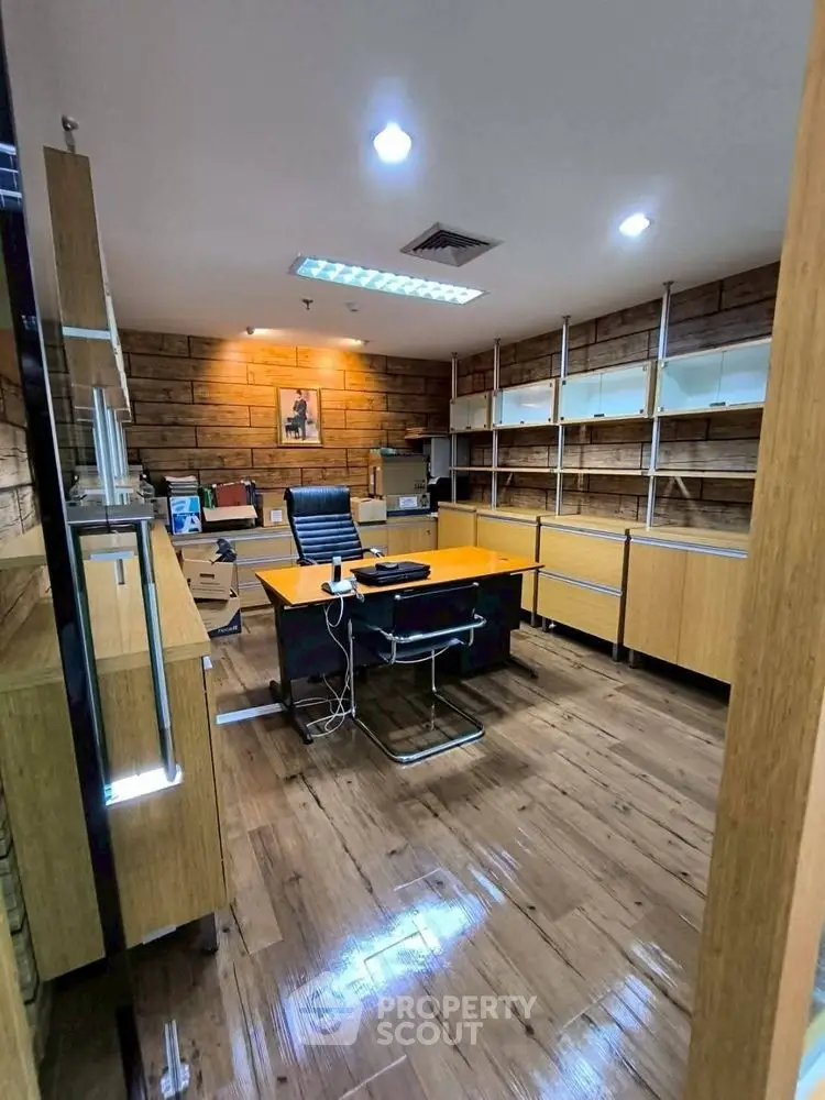 Modern study room with wooden flooring and sleek furniture