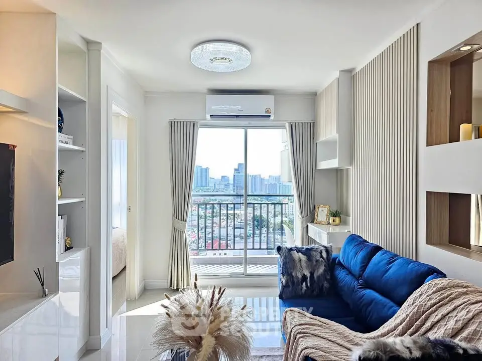 Modern living room with city view, blue sofa, and elegant decor in a high-rise apartment.