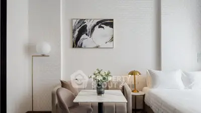 Elegant modern bedroom with stylish decor and cozy seating area, perfect for relaxation and comfort.