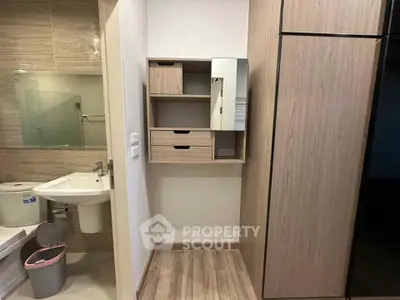Modern bathroom with sleek wooden cabinetry and glass shower enclosure