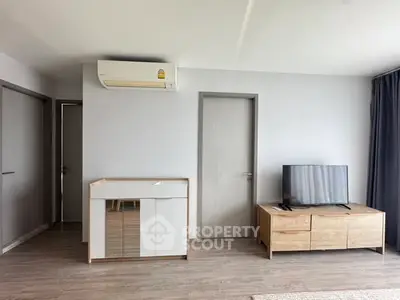 Modern living room with sleek furniture and air conditioning, perfect for comfortable living.