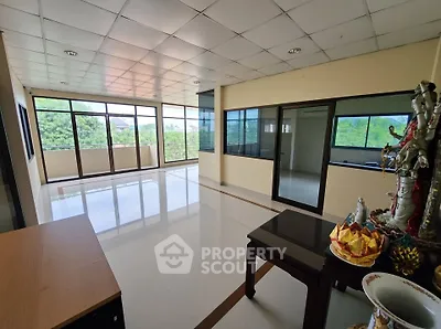 Spacious corner unit with large windows offering lush green views, ideal for a serene living space.