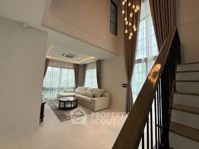 Luxurious living room with high ceiling and elegant chandelier