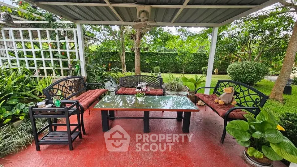 Charming garden patio with cozy seating and lush greenery, perfect for outdoor relaxation and entertaining.