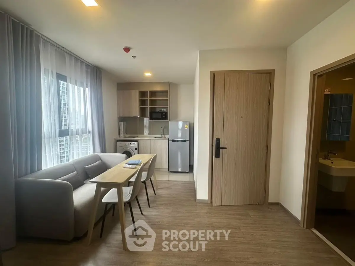 Modern apartment interior with cozy living area and compact kitchen