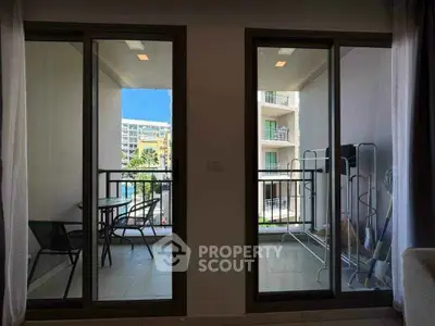 Modern apartment balcony with pool view and outdoor seating