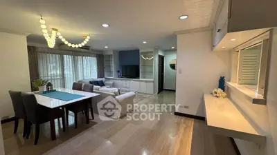 Spacious living and dining area with elegant lighting and modern decor